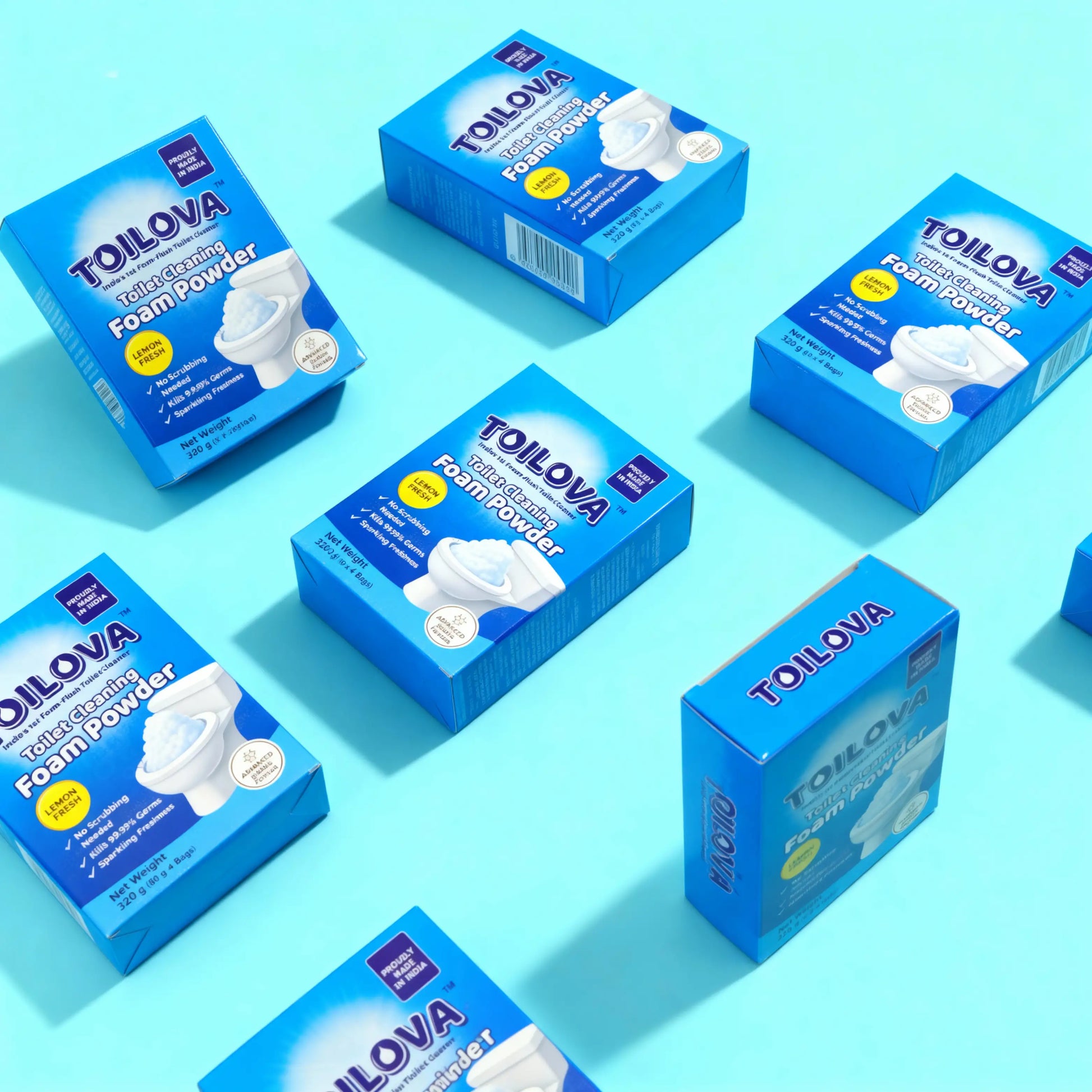 Multiple boxes of Tolova foam powder on a light blue background